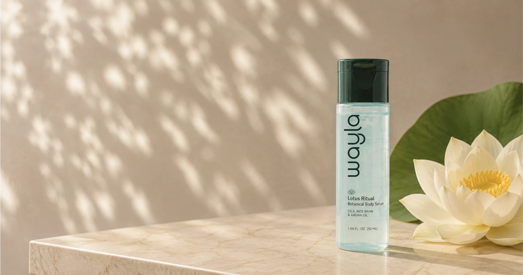 Wayla Lotus Ritual Botanical Body Serum, 50 mL, beside a white lotus flower